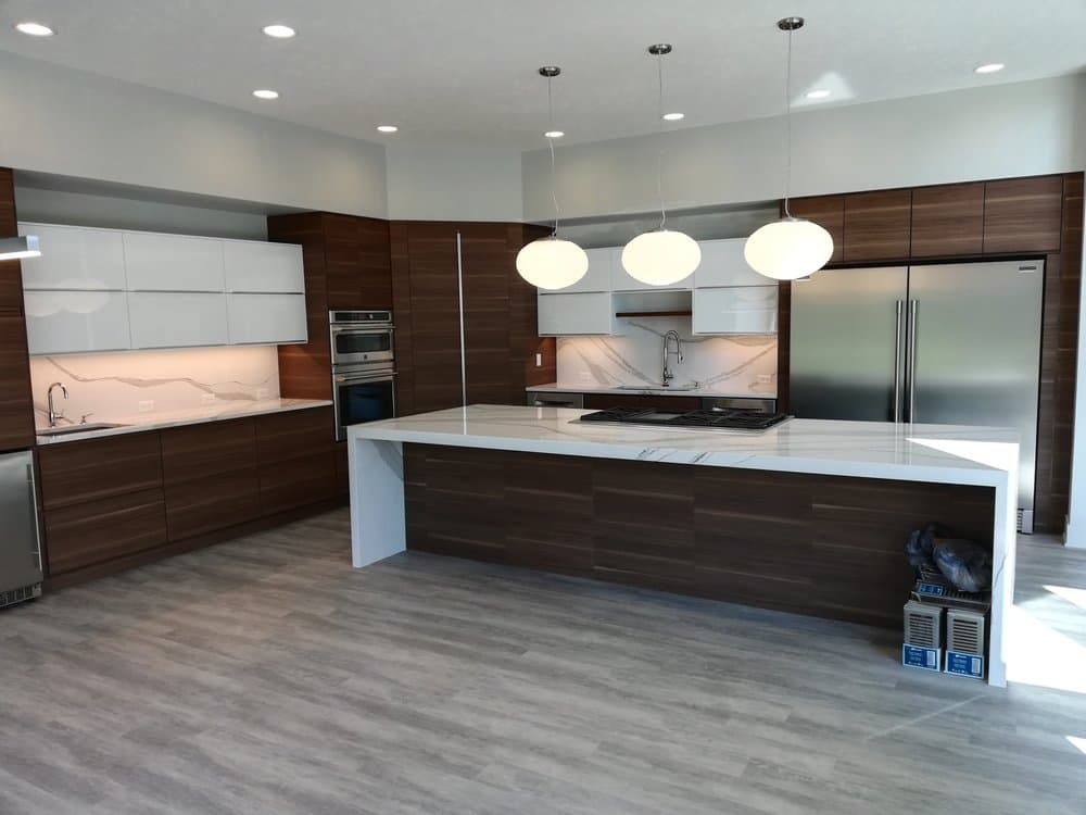 Contemporary kitchen with walnut cabinetry and pendant lighting